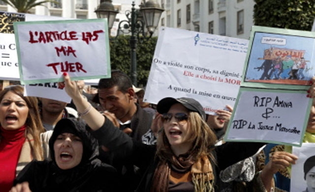 Women shout slogans as they protest against the suicide of Amina al-Filali, 16, who was forced to marry the man who raped her outside parliament in Rabat. (AFP)